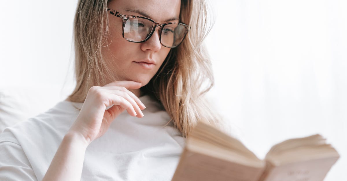 What factors to consider for a long lasting salad? - Low angle of crop concentrated female in eyeglasses touching chin while reading novel at free time