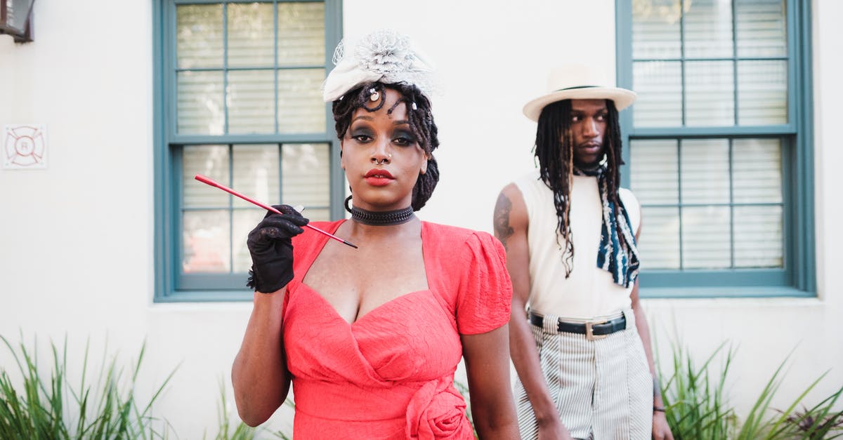 What flavorants stand up to long cooking? - Woman in Elegant Red Dress Holding Cigarillos and Man with Dreadlocks Standing Behind