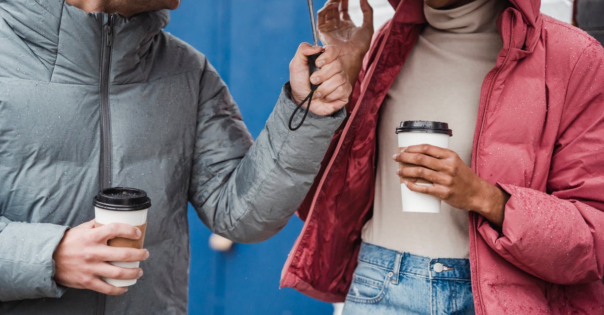 What green tea has the highest caffeine content? - Crop multiethnic couple with coffee on rainy day