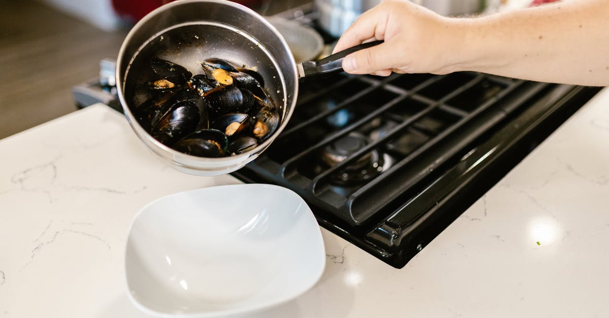 What happened, when I boiled this pot dry? - Hand Holding Pot with Boiled Mussels