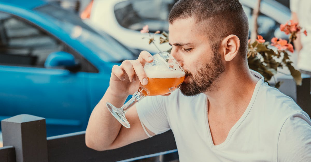 What happens during a cold fermentation that makes bread taste so good? - Good looking man drinking beer in street cafe