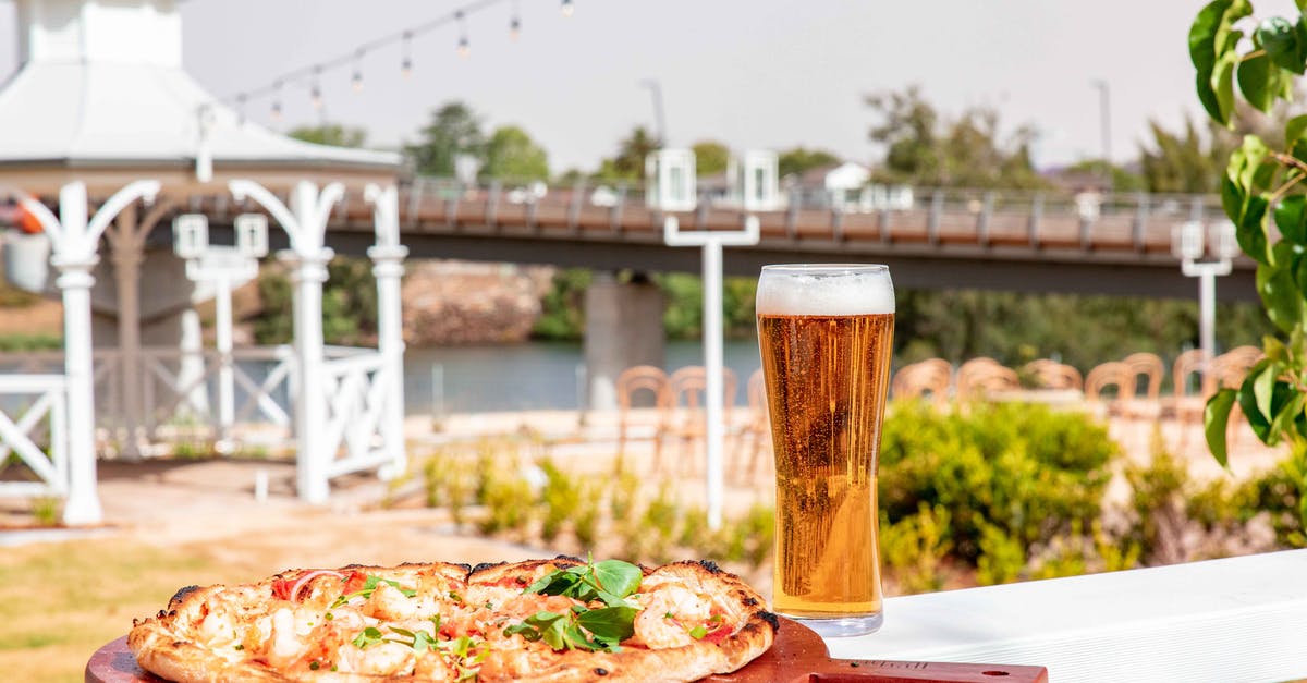 What herbs would be effective in Pizza dough? [closed] - A Glass of Beer and Pizza on Wooden Board