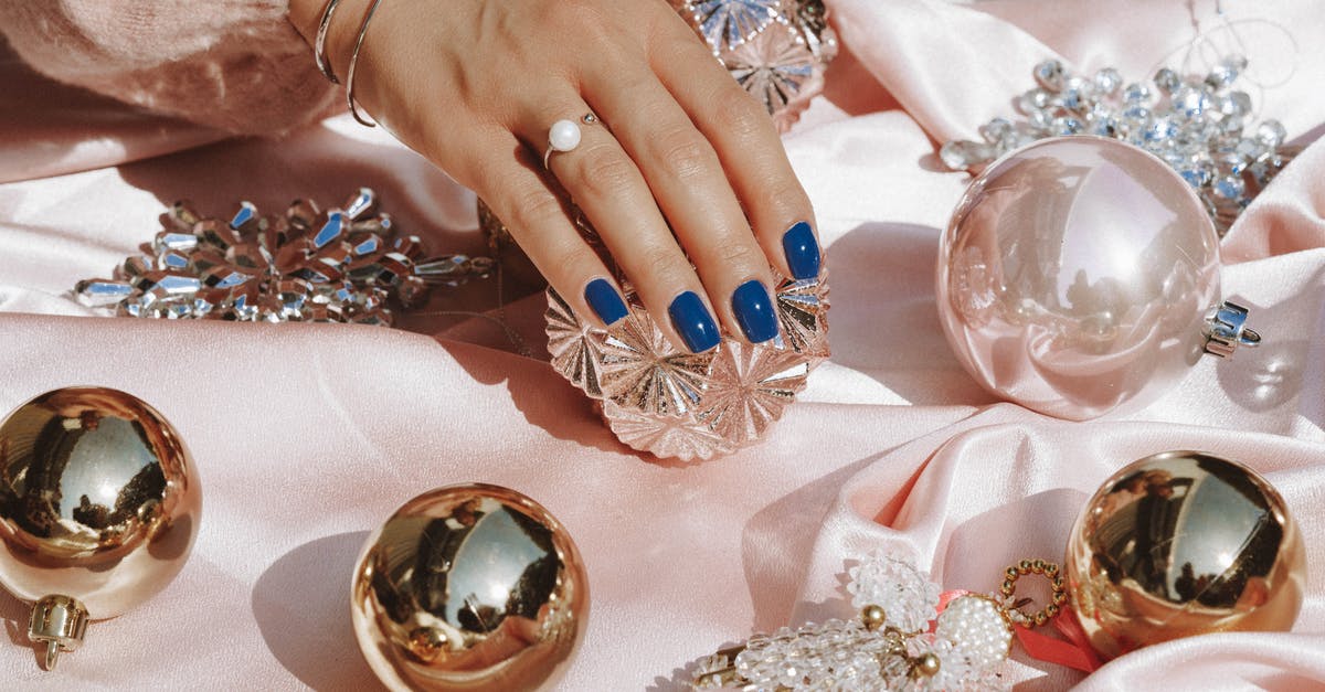 What is a 'parmigiano pearl'? - Person Wearing Gold Ring and Blue Manicure