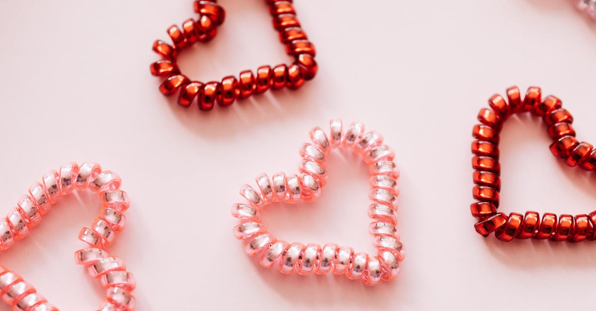 What is a 'parmigiano pearl'? - Colorful hair ties in shape of hearts on pink surface