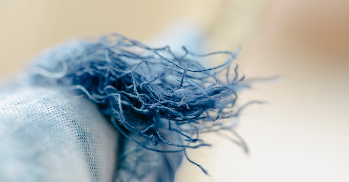 what is a loose spice? - Closeup of colorful loosen threads of natural blue textile hung on clothesline on blurred background