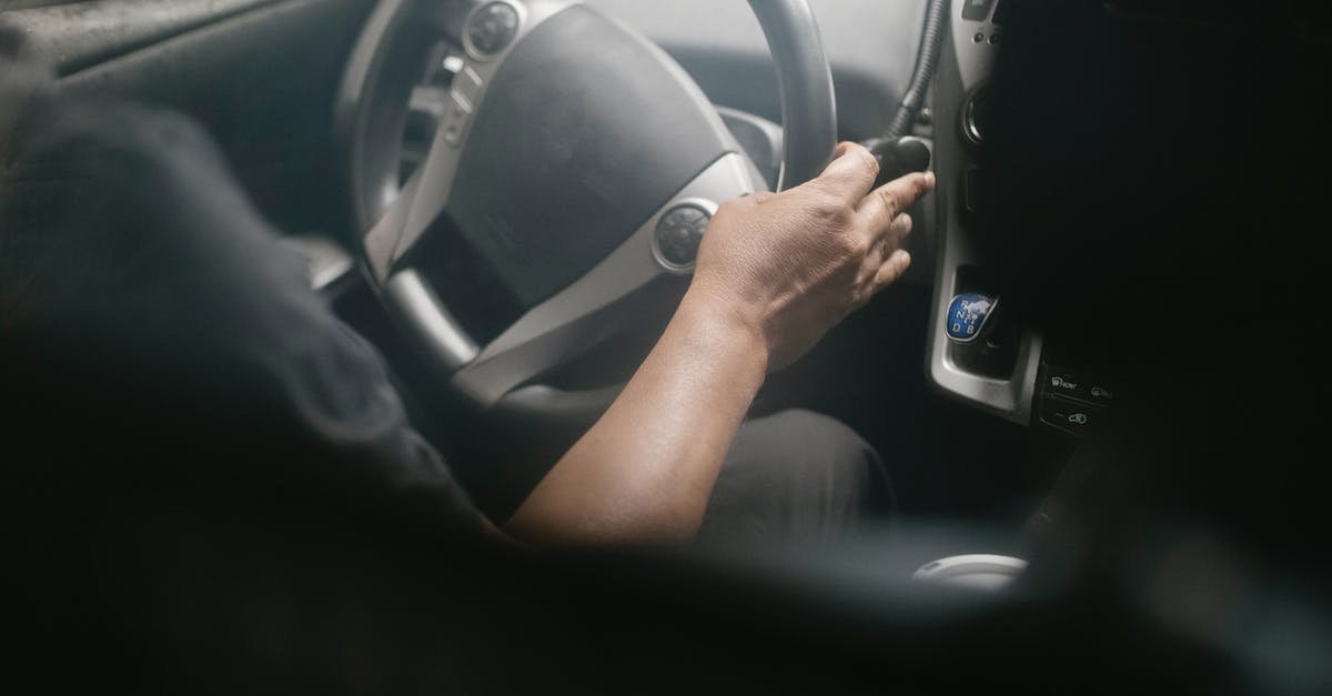 What is an easy way to turn a heavy-ish cake? - High angle of crop unrecognizable male driving modern car on street on sunny day