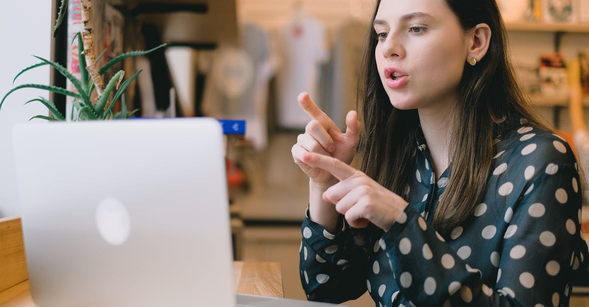 What is distilled or freeze-concentrated mead called? - Focused young woman having video call on netbook in modern workspace