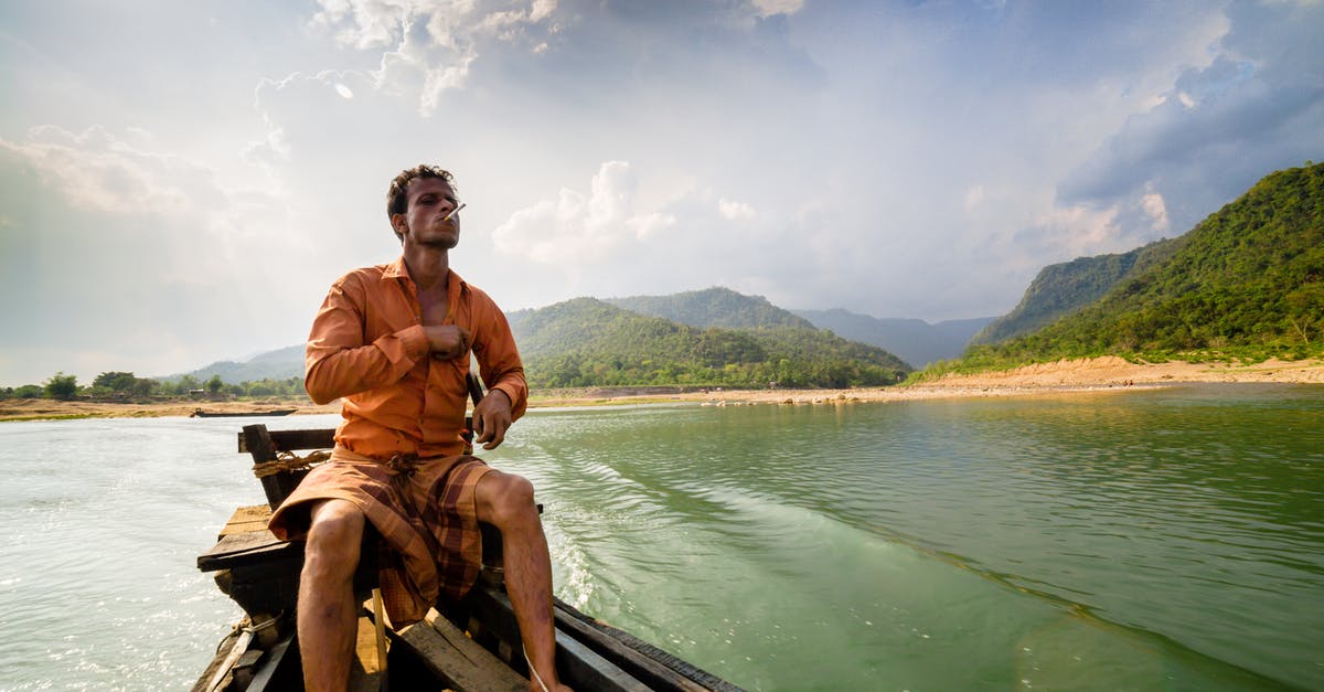 What is good water-pan placement for offset smoker - Photo of Man Sitting on Motor Boat