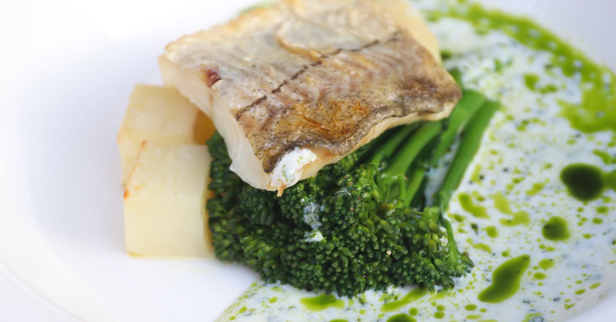 What is helping fried fish have more flavour? - Delicious fish with broccoli on plate