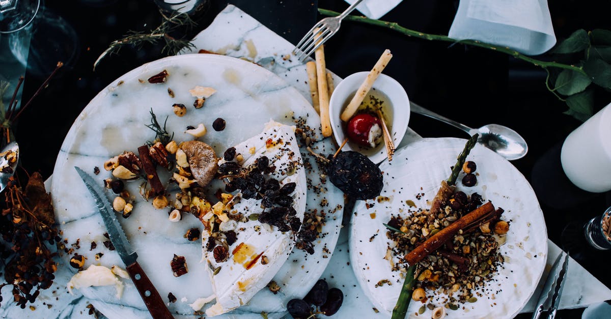 What is leftover in the pulp after making oat milk and how can you use it? - From above of plates with remains of various dishes left after festive dinner on table with cutlery and flowers