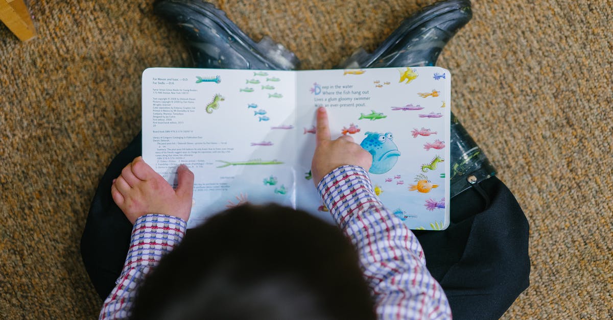 What is my fish's story? - Photo of a Boy Reading Book