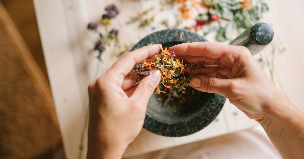 What is tamur (ingredients)? - Close-up of Woman Mixing Herbs and Spices