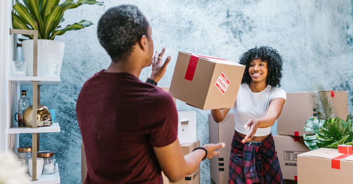 What is the best method of storage for condiments? - Woman Throwing Moving Box to Friend