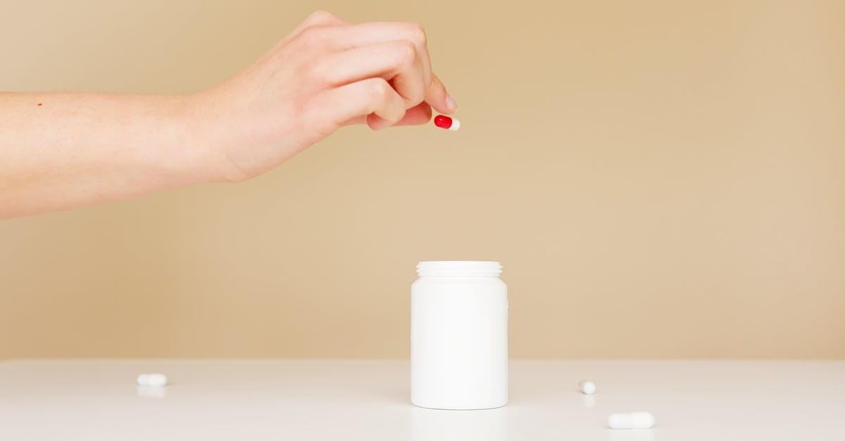 What is the best technique to put icing on plastic? - Crop woman putting scattered pills back in jar