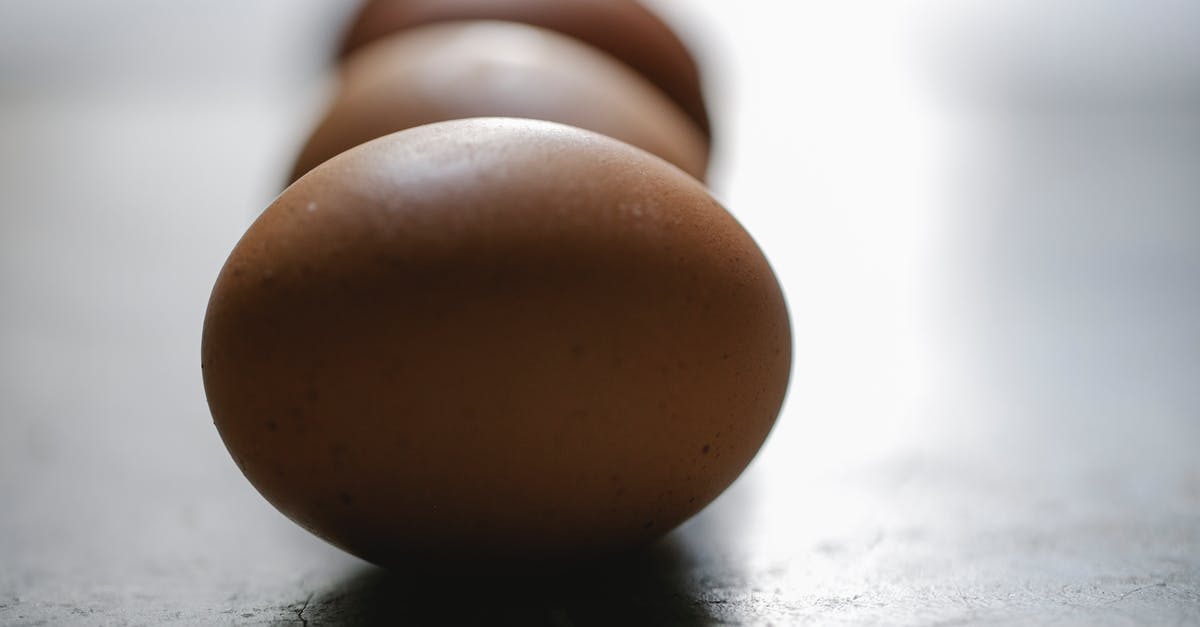 What is the difference between a hen and a chicken? In terms of cooking, flavor, price, and anything else culinary related. - Row of brown chicken eggs placed on table in kitchen