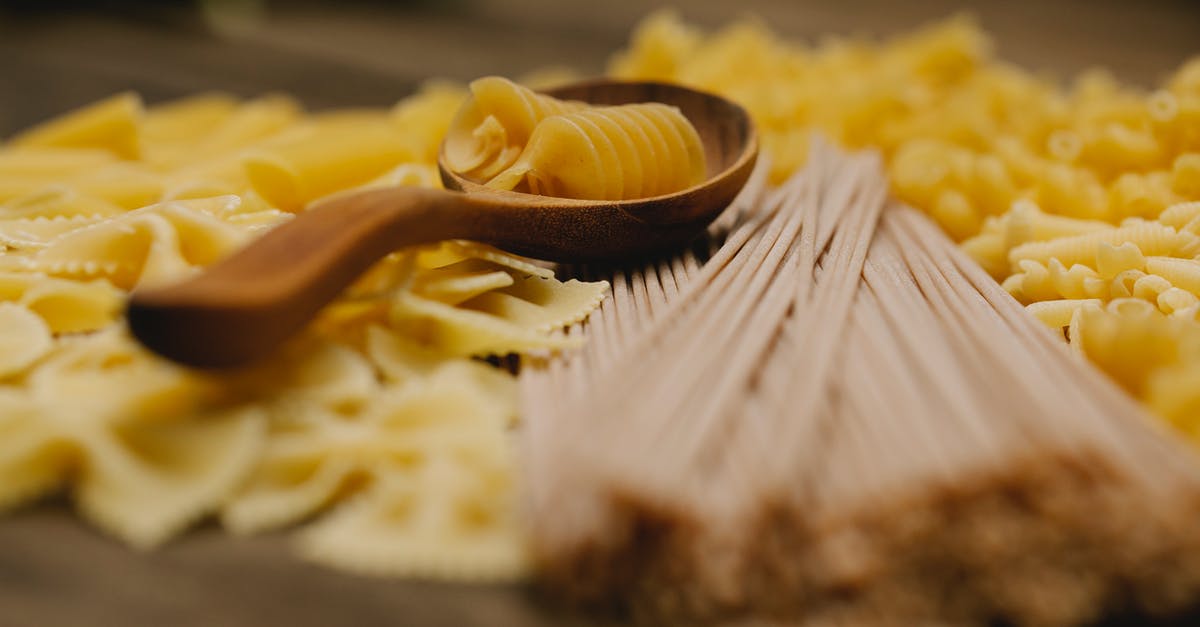 What is the difference between cracked wheat and wheatgerm? - Fusilli in wooden spoon among farfalle and spaghetti