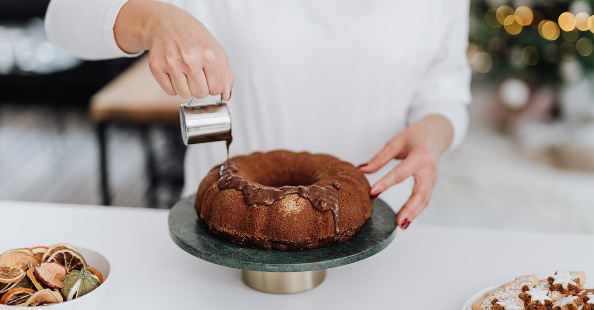 What is the difference between Devil's Food and Chocolate cake? - Person in White Dress Shirt Holding Brown Round Cake