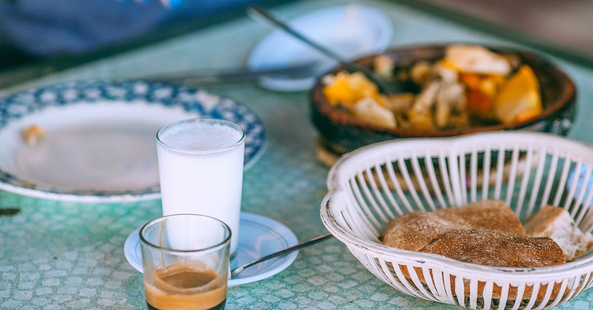 What is the difference between French-pressed and Turkish coffee? - Person eating traditional food with milk and coffee in glasses at table in daylight