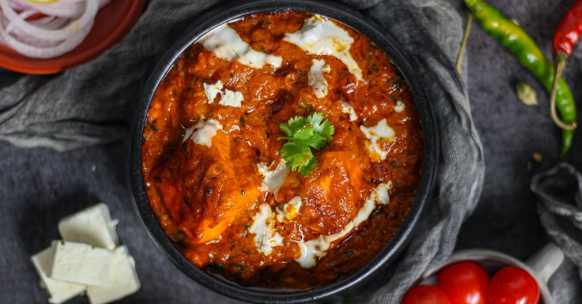 What is the difference between malai paneer and paneer? - Cooked Food in Black Ceramic Bowl