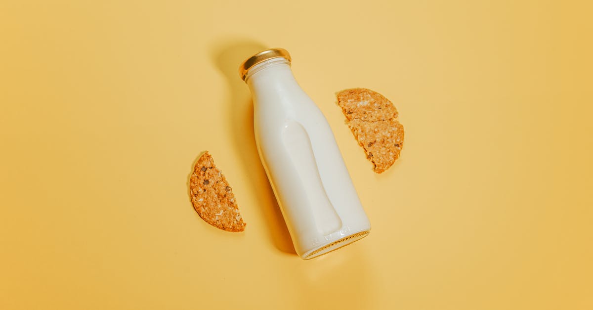 What is the difference between milk (simple) and milk drink? - Bottle of milk with cookies on surface