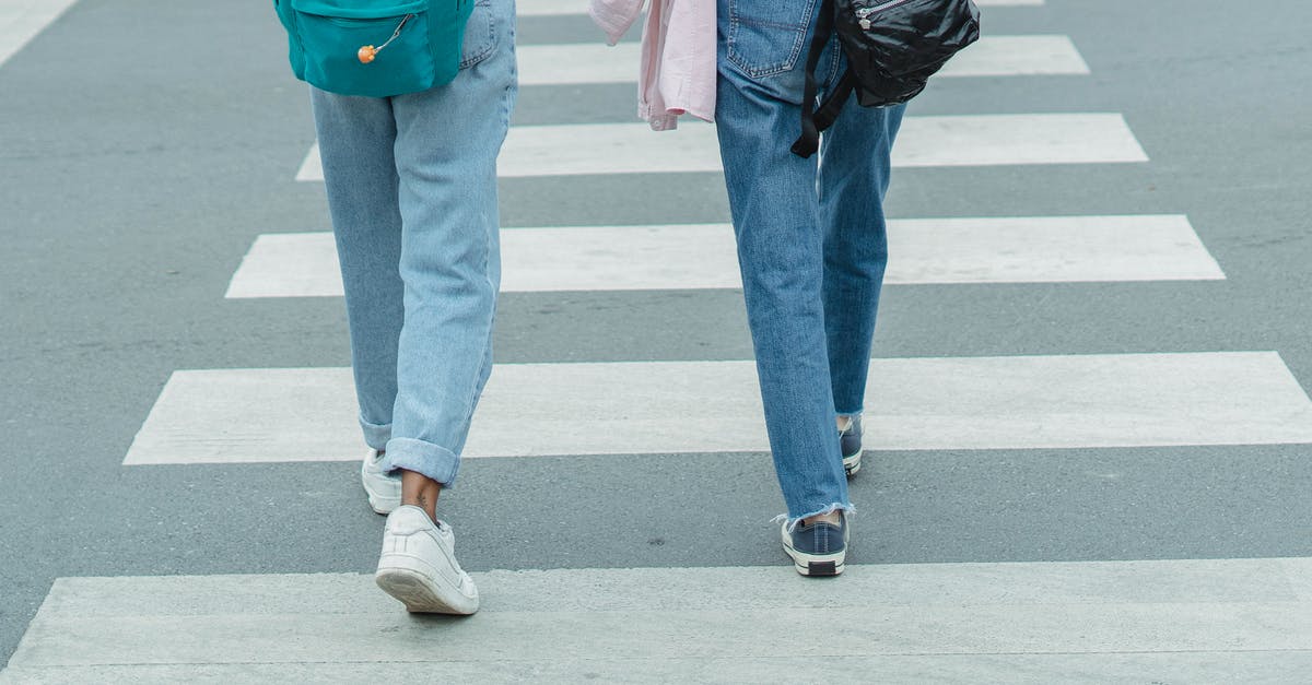 What is the easiest way to remove chicken leg/drumstick tendons? - Unrecognizable women wearing jeans crossing city street