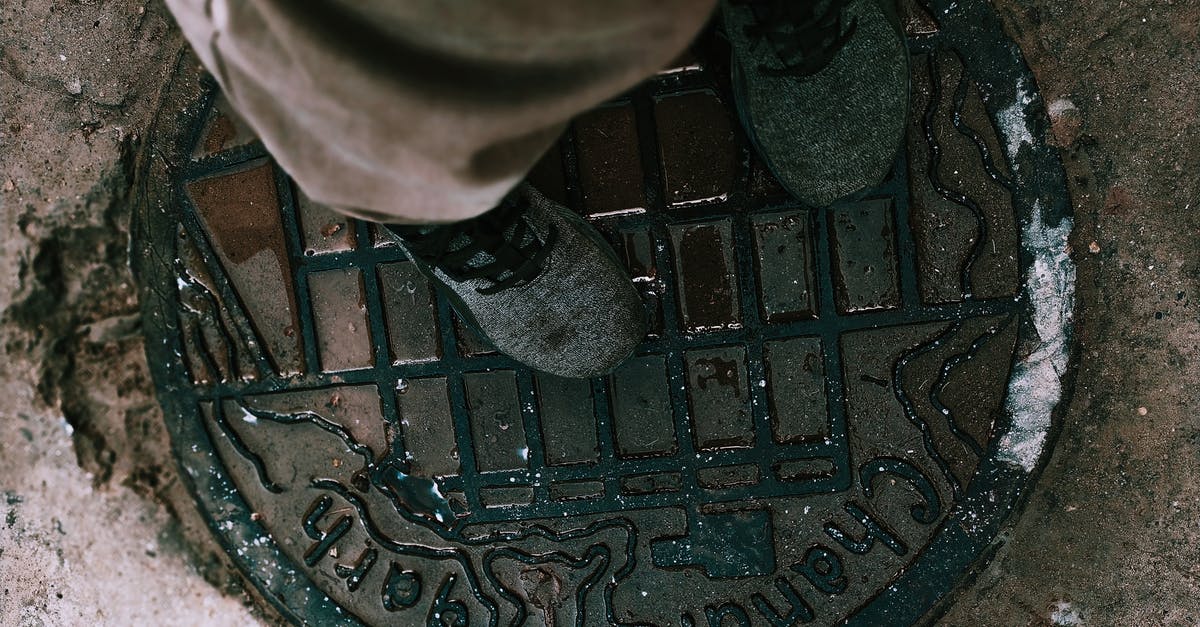 What is the easiest way to remove chicken leg/drumstick tendons? - From above anonymous person in boots and pants standing on shabby metal manhole lid on city street