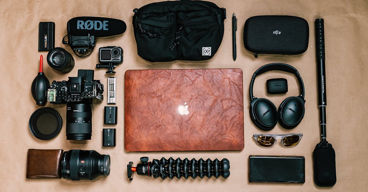 What is the film on top of tea? - Overhead view of laptop and photo camera composed with headphones and other gadgets of professional photographer