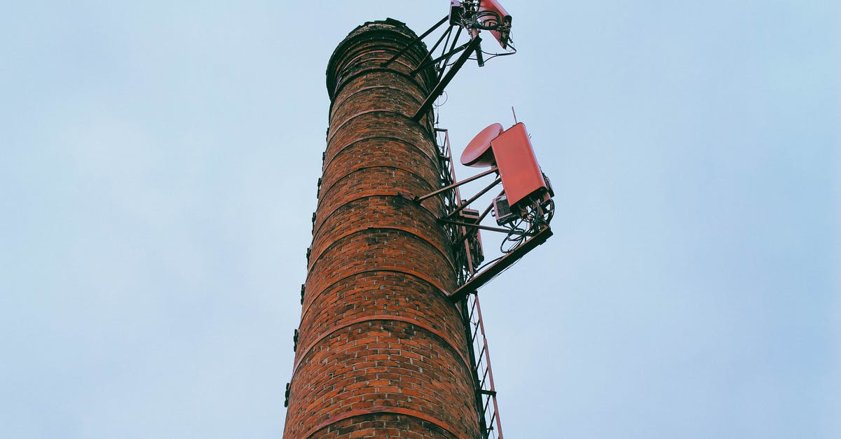 What is the impact of high heat on wine? - From below of high chimney of factory boiler room made of brick with metal ladder located against cloudless blue sky