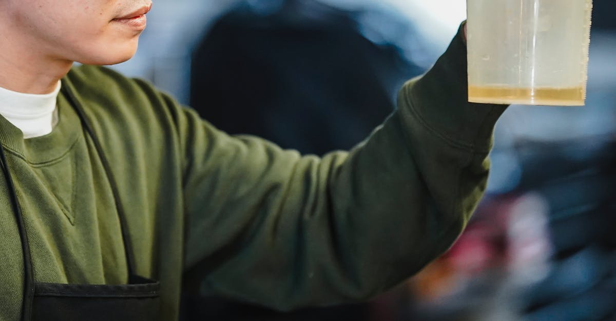 What is the measurement of 1 cup? [duplicate] - Photo of a Man Holding a Cup with Yellow Liquid