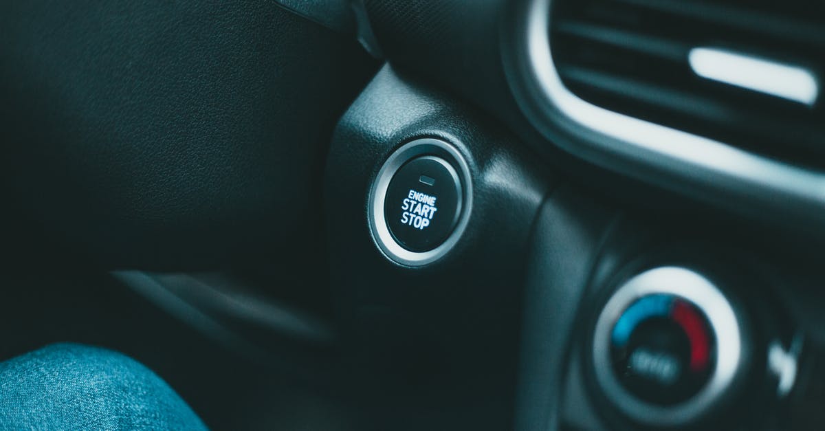 What is the most comfort temperature for tea? - Closeup of black shiny dashboard with engine start button and conditioner controller of modern car in daylight