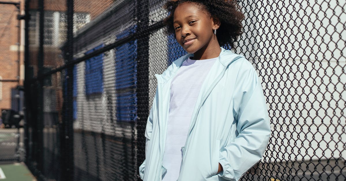 What is the net (absorbable) carb content of Psyllium Husk? [closed] - Positive African American schoolgirl in sportswear standing near metal net fence on sports ground and looking at camera