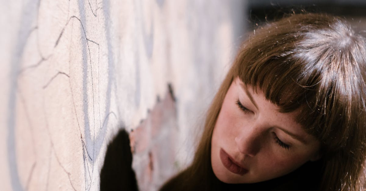 What is the puffy bread shown in Chitty Chitty Bang Bang? - Crop dreamy adolescent near graffiti wall in city