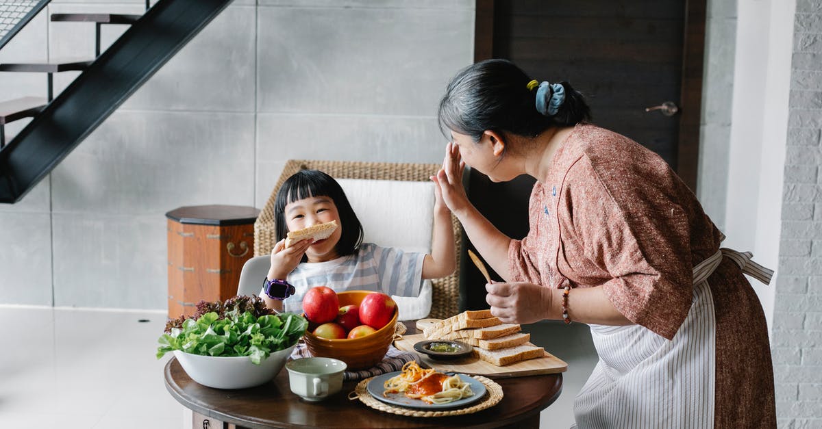 What is the purpose of nutmeg in apple zucchini bread? - Happy grandmother with little girl during lunch