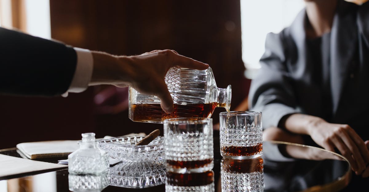 What is the purpose of Whiskey rocks? - A Person Pouring Drinks at a Table