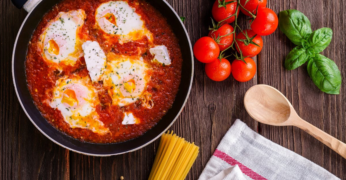 What is the recommended temperature for cooking eggs? - Black Frying Pan With Spaghetti Sauce Near Brown Wooden Ladle and Ripe Tomatoes