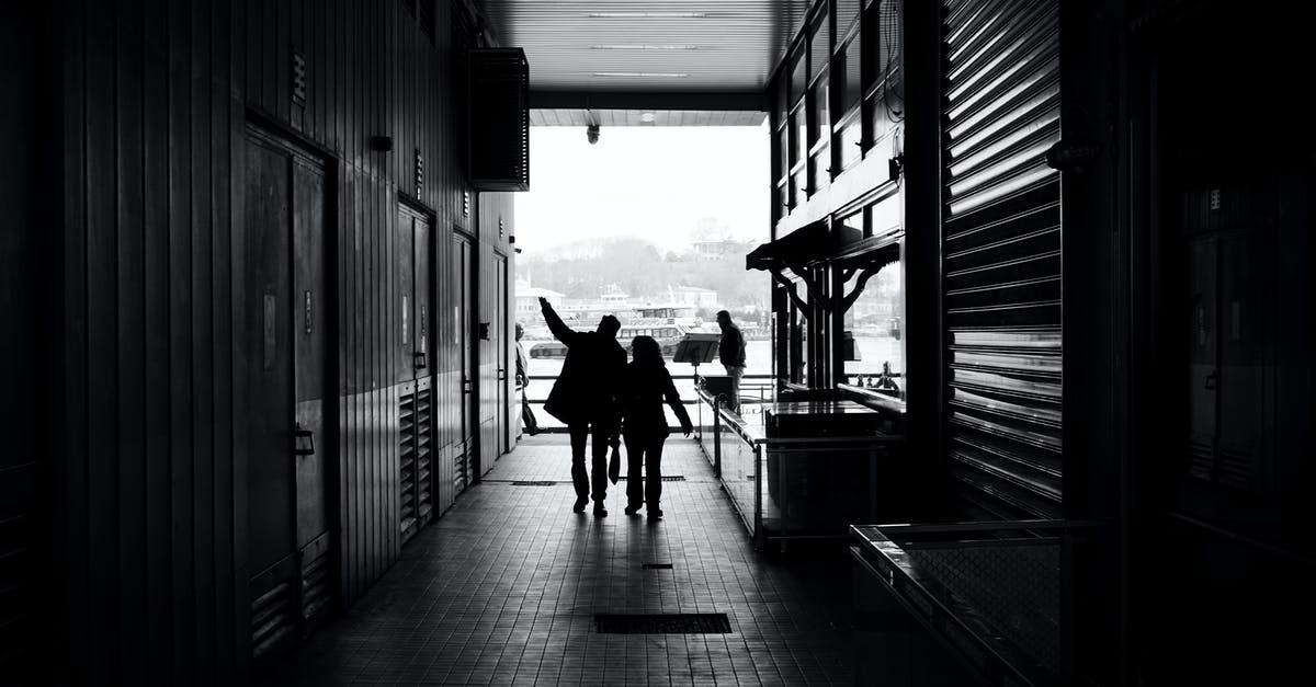 What is the relationship between salt and iodine? - Couple silhouettes walking on narrow passage of modern building