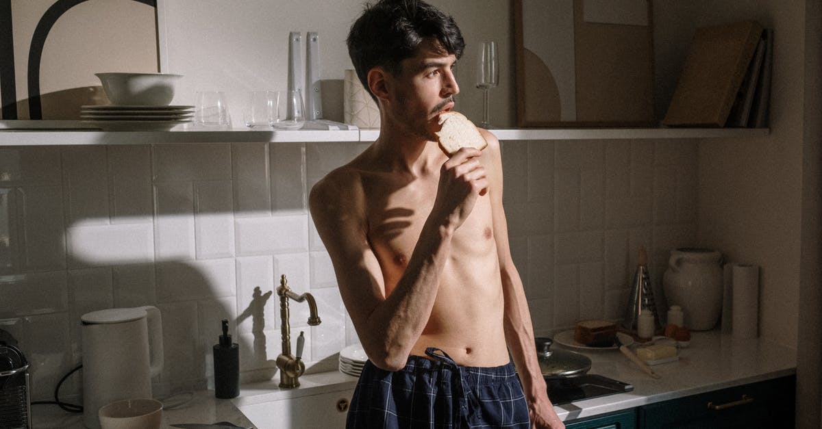 What is the shelf life of dehydrated, precooked meals? - Man in Blue and White Plaid Shorts Standing Near Kitchen Sink