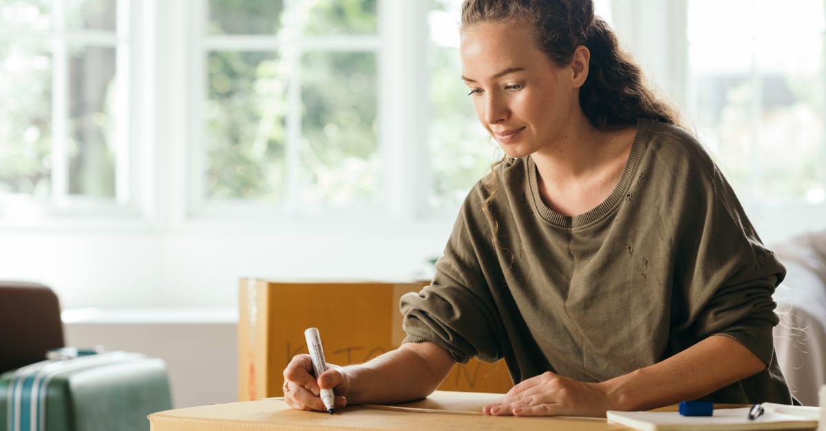 What is the stringy slimy stuff in Peace Tea? - Calm lady sitting on sofa and signing box with belongings in cozy house in sunny day while moving out