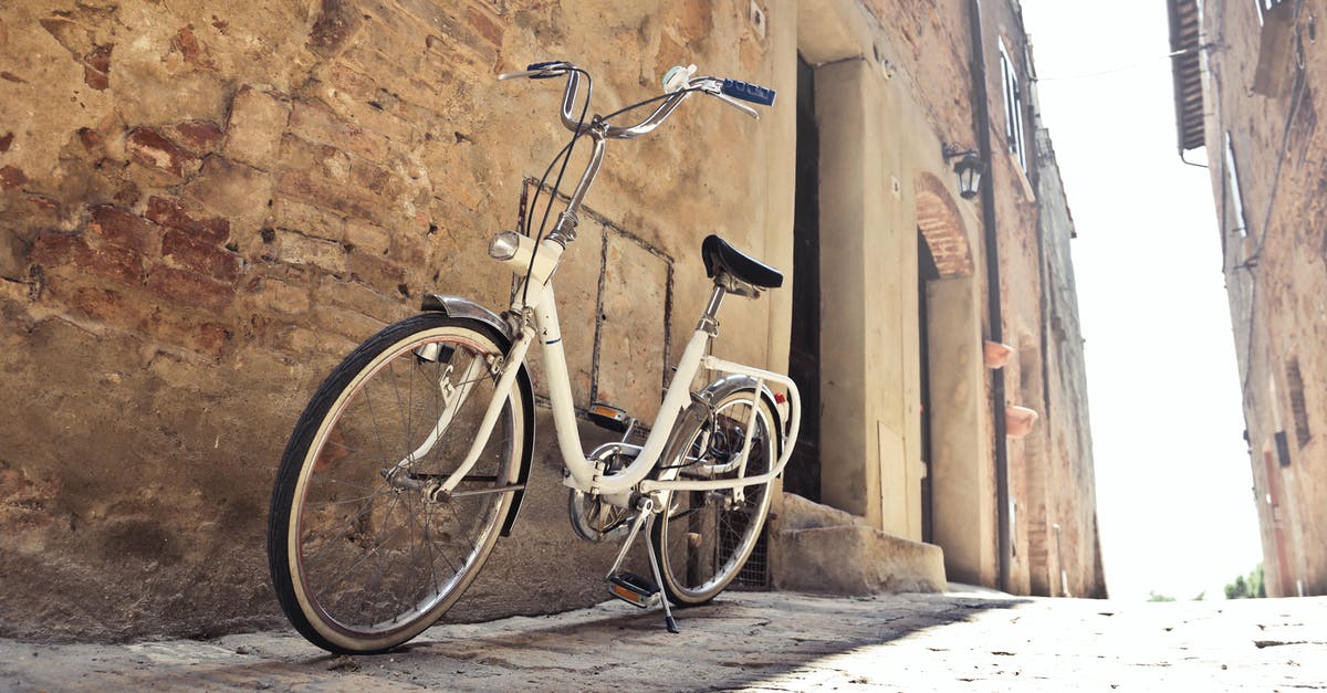 What is the traditional way to layer a lasagna? - Bicycle parked on narrow street against old building with shabby walls in town