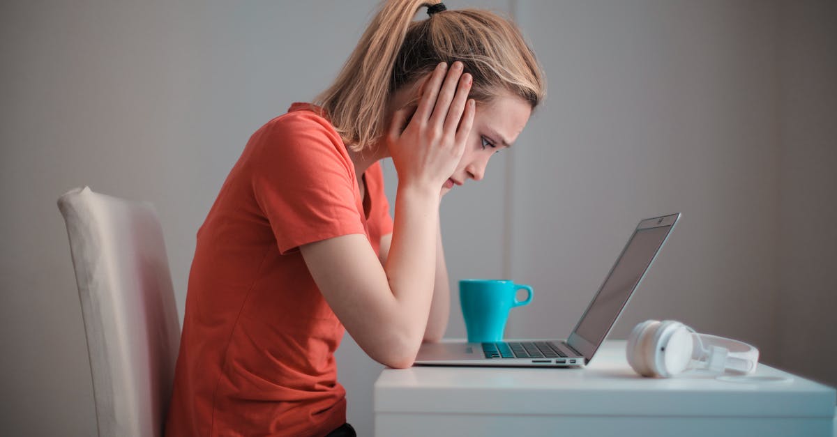 What is the use of this device? Perhaps a potato masher? - Young troubled woman using laptop at home