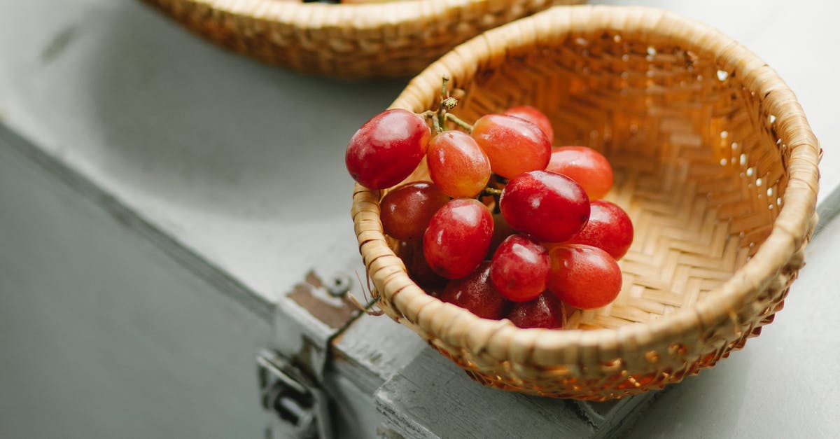 What is the white dust on red grapes? - Basket with fresh bunch of grapes