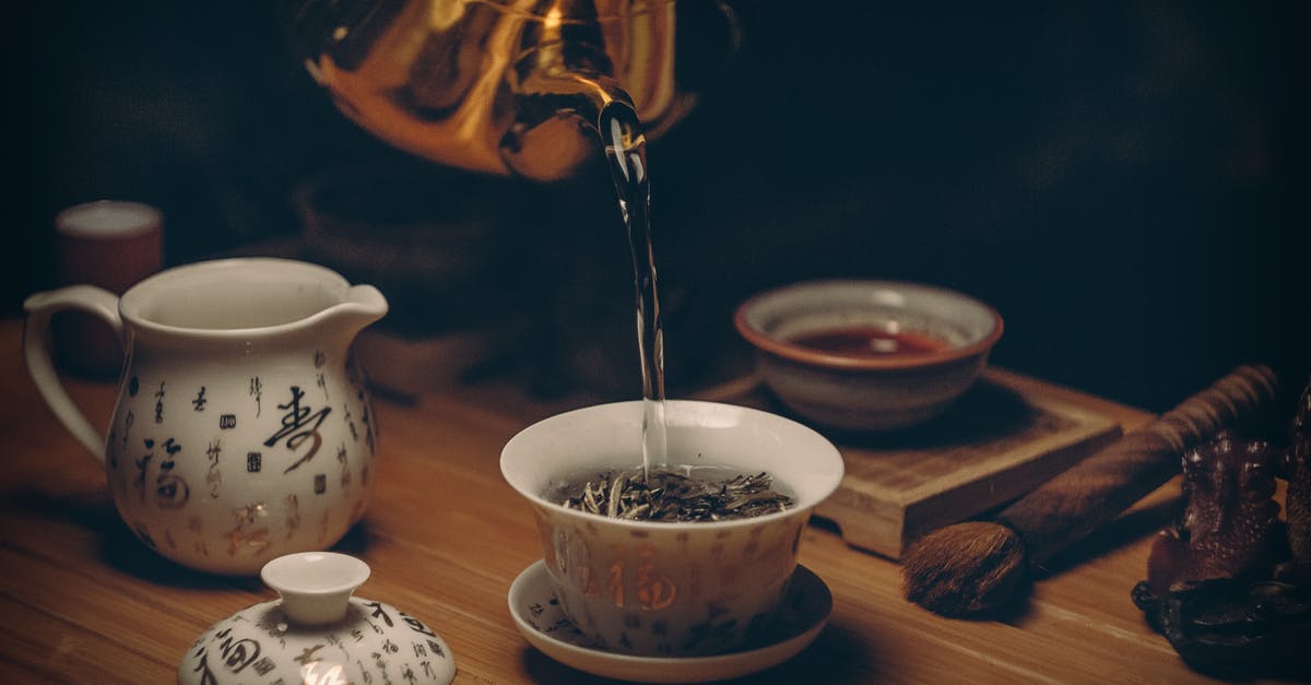 What is this Ceramic Container? - Gold Kettle Pouring Hot Water on Cup of Tea