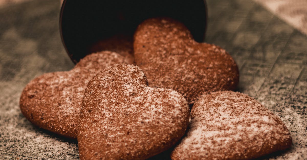 What is this dipped powder cookie called? - Appetizing heart shaped cookies with sugar powder placed on napkin