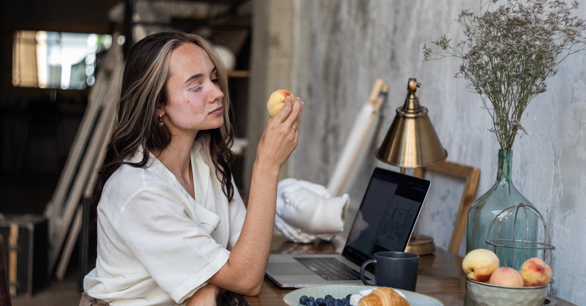 What is this fruit called? - Woman in White Button Up Shirt Sitting by the Table With Fruits on Plate