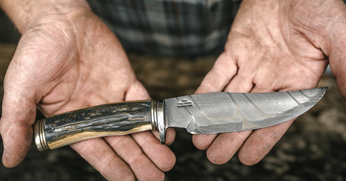 What is this one-handed tool with five dull steel "blades" called? - Person Holding Silver and Gold Knife