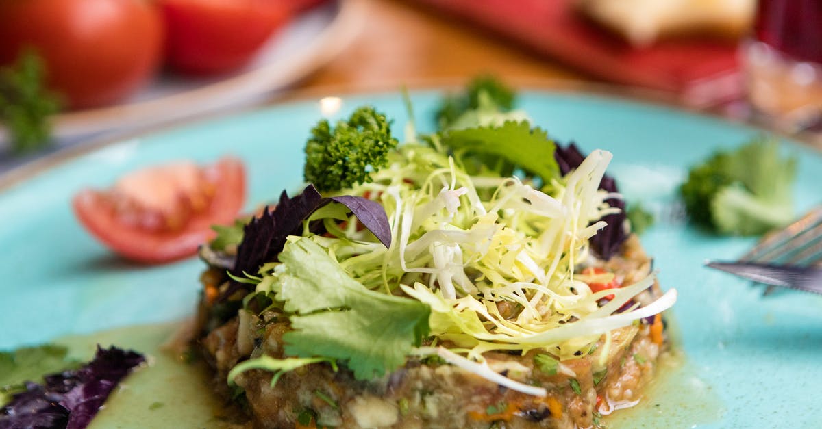 What is this sandwich-salad dish? - Green Vegetable on White Ceramic Plate