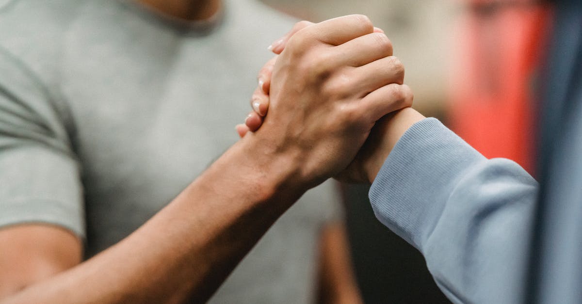 What is this sauce-making technique called? - Crop sportive couple clasping hands in gym