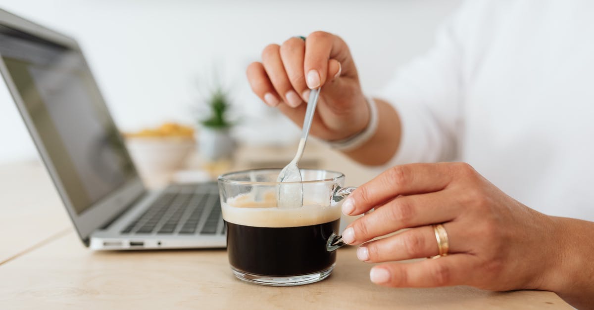 What is this spoon? - Person Holding Silver Spoon in Black and White Ceramic Mug