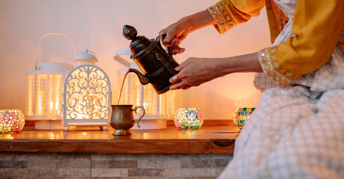 What is this teapot and where can I buy it? - Woman in Yellow Shirt Pouring Tea on Brown Ceramic Teacup