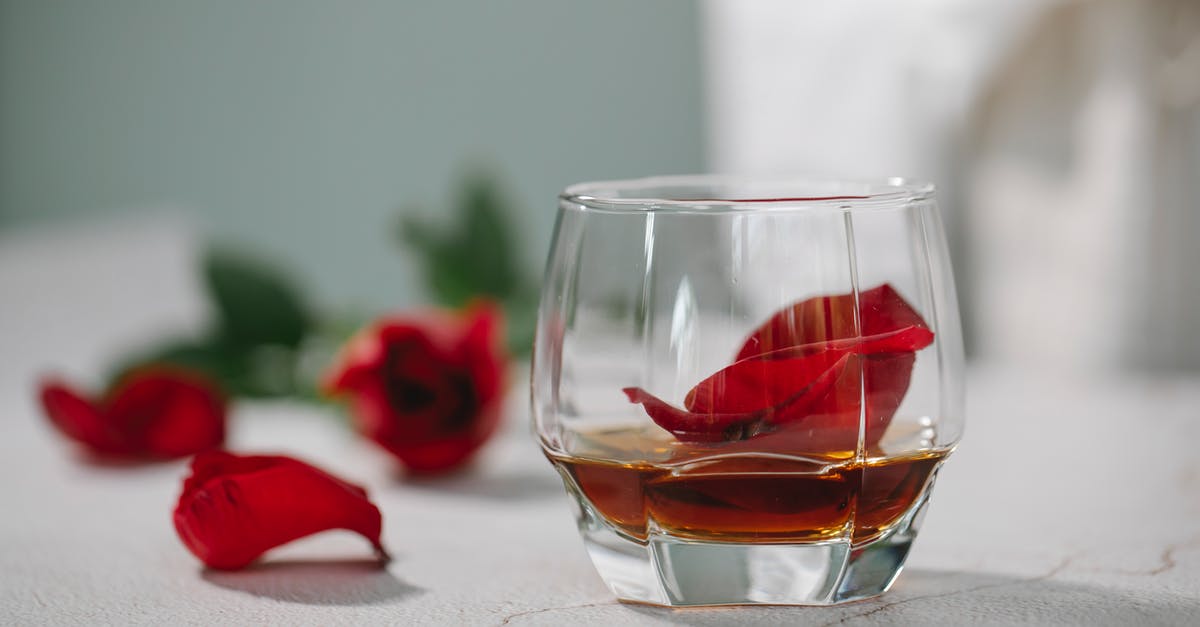 What kind of bourbon is best for making whiskey balls? - Glass of alcoholic drink with petals